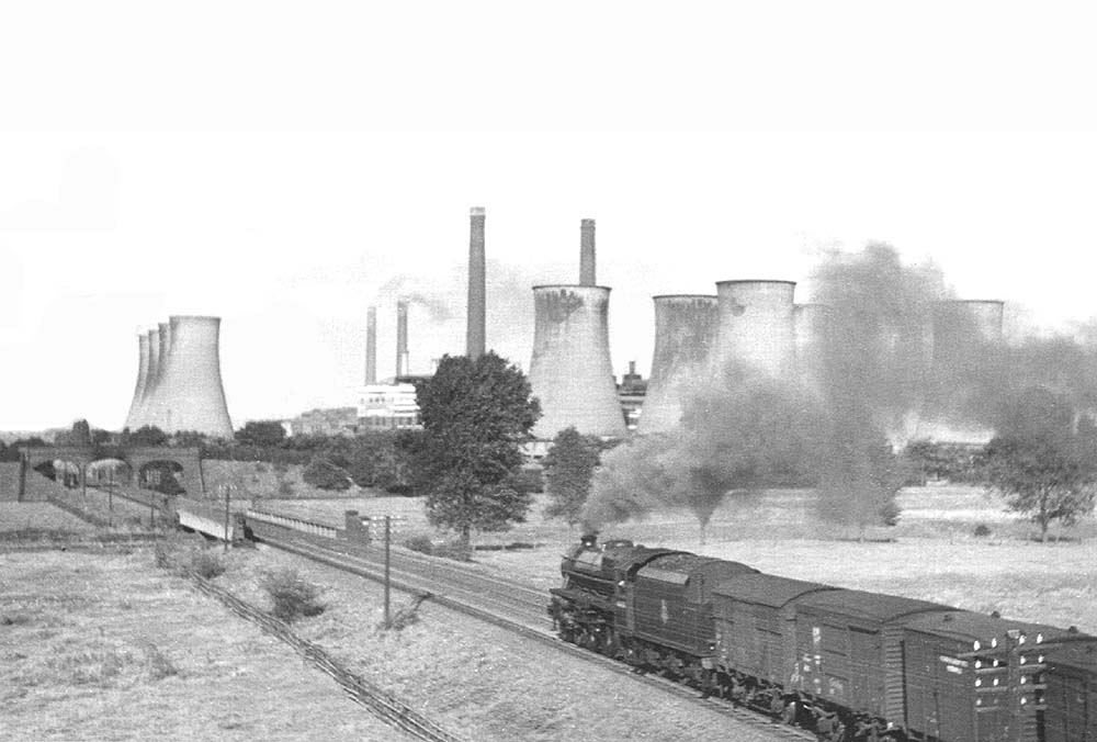 An unidentified ex-LMS 'Black Five' is seen on a fitted freight heading North on the fast line to Kingsbury Station on 1st September 1952
