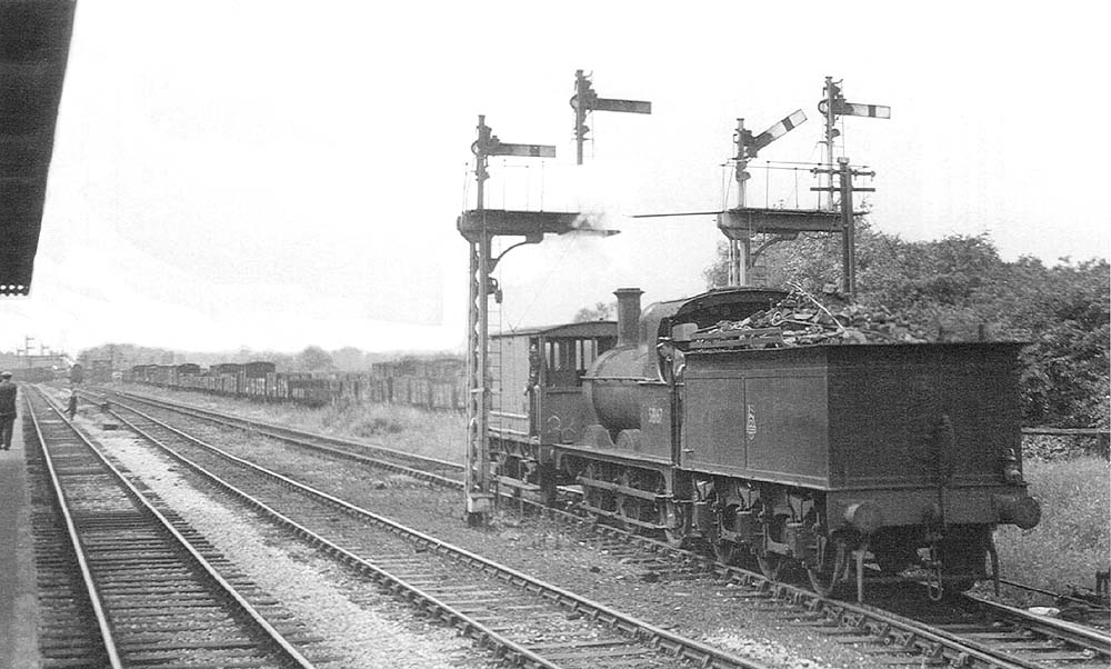 Ex-MR 0-6-0 2F No 58167 is seen running tender first whilst towing a brake van as it leaves Water Orton sidings on 6th August 1952