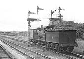 Ex-MR 0-6-0 2F No 58167, runs tender first whilst towing a brake van, leaving the sidings on 6th August 1952