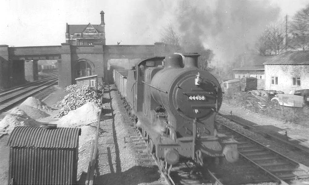 Ex LMS 4F 0-6-0 No 44458 passes Water Orton station and on to the fast lines to Kingsbury with a train of empty mineral wagons
