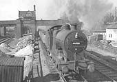 Ex LMS 4F 0-6-0 No 44458 passes Water Orton station with a train of empty mineral wagons for Kingsbury