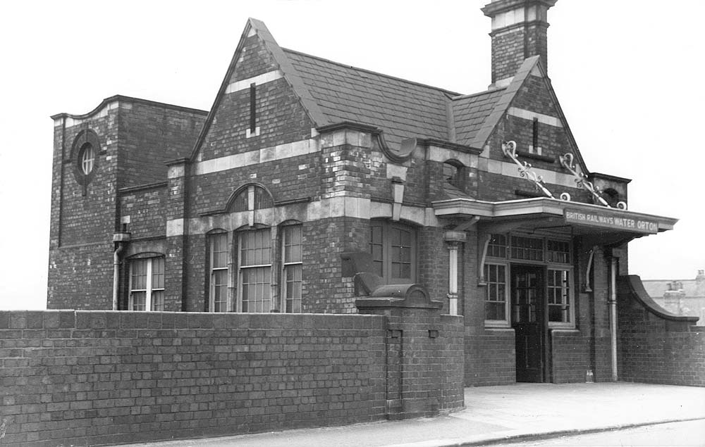 An exterior road level view of Water Orton station showing the goods entrance on the left and the passenger entrance on the right