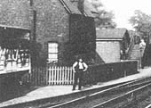 Close up showing the lime stained cattle wagon standing on the siding with a railway worker posed for the camera