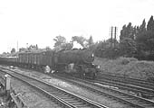 An unidentified ex-WD 2-8-0 locomotive approaches Water Orton from the Derby line on a Class F express freight service