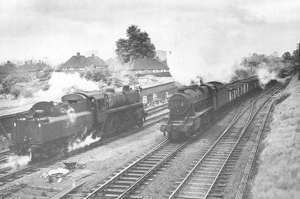 Ex-LMS 8F 2-8-0 No 48247 passes British Railways Standard Class 4 2-6-0 No 76086 at Water Orton junction on 21st May 1966