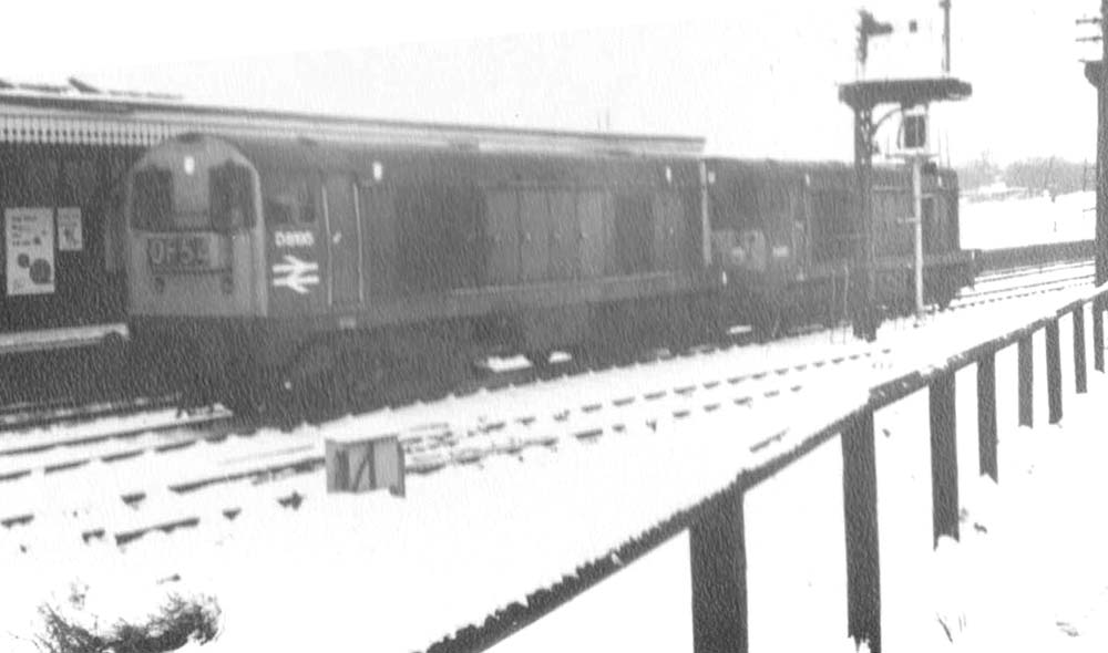 Two unidentified English Electric Type 1 locomotives pass through Water Orton station towards Derby on a very wintry day