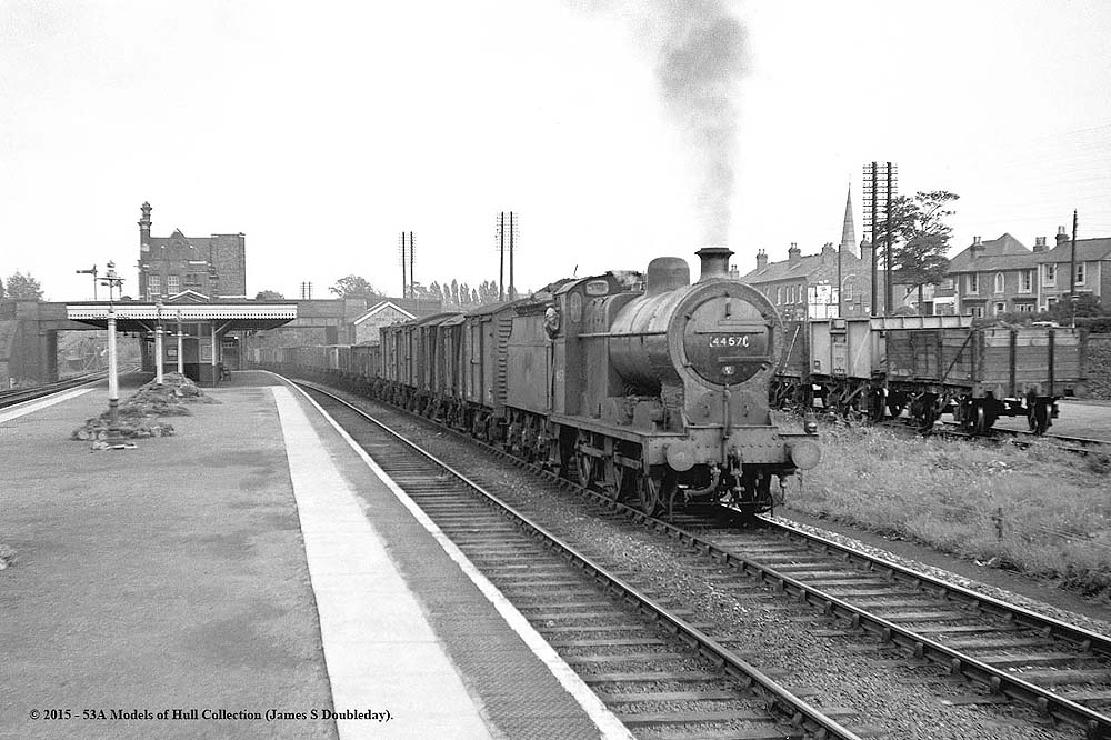 Ex-LMS 4F 0-6-0 No 44571 passes through Water Orton station with a westbound Class K pick-up freight circa 1959