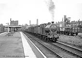 Ex-LMS 4F 0-6-0 No 44571 passes through Water Orton station with a westbound Class K pick-up freight circa 1959