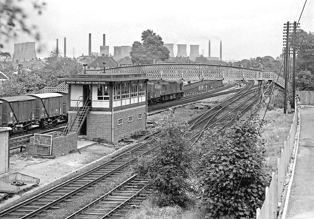 An unidentified British Railways Sulzer Type 2 diesel is seen passing the British Railways Signal Box on its way to Kingsbury Junction