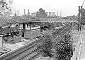 An unidentified British Railways Sulzer Type 2 diesel is seen passing the British Railways Signal Box on its way to Kingsbury Junction