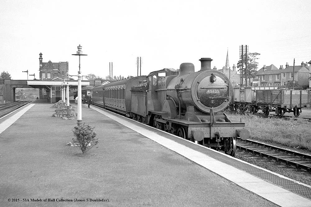 Ex-MR 2P 4-4-0 No 40439 stands at Water Orton with a Nuneaton to Birmingham ordinary passenger service circa 1959