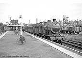 Ex-MR 2P 4-4-0 No 40439 stands at Water Orton with a Nuneaton to Birmingham ordinary passenger service circa 1959