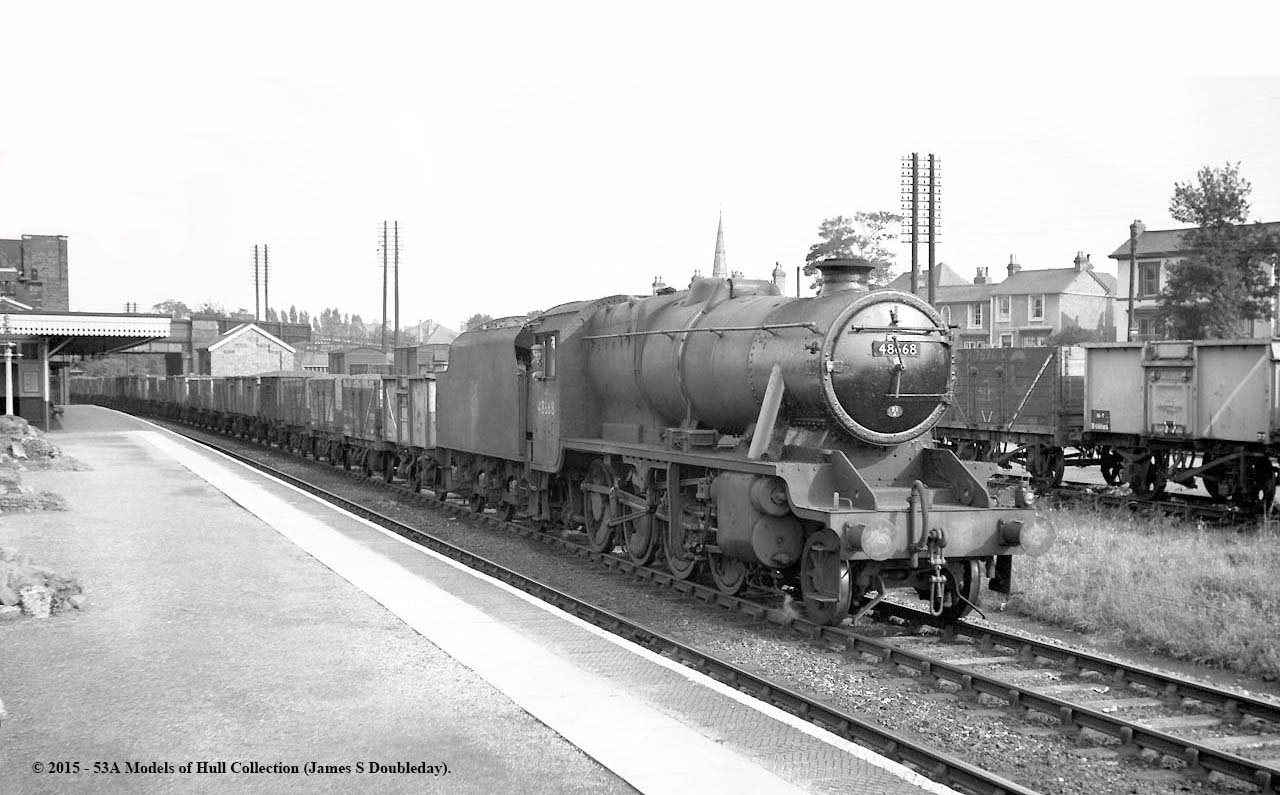 Ex-LMS 8F 2-8-0 No 48668 heads a westbound Class K mineral train through Water Orton station circa 1959