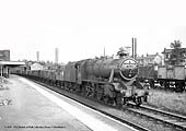 Ex-LMS 8F 2-8-0 No 48668 heads a westbound Class K mineral train through Water Orton station circa 1959