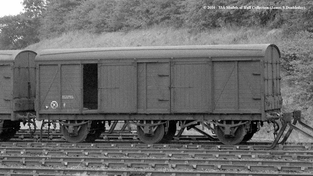 An ex-LMS six wheel Covered Combination Truck, or CCT Diagram 1871 built circa 1926, is stabled hard up to buffer stops at Water Orton in 1959