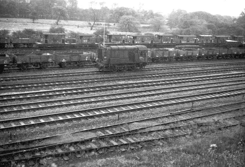 British Railways Diesel Shunter 0-6-0 D3775 runs past empty wagons at Water Orton goods sidings in the early 1960s