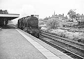 An unidentified ex-LMS 4-6-0 'Black 5' is seen passing light engine through Water Orton station
