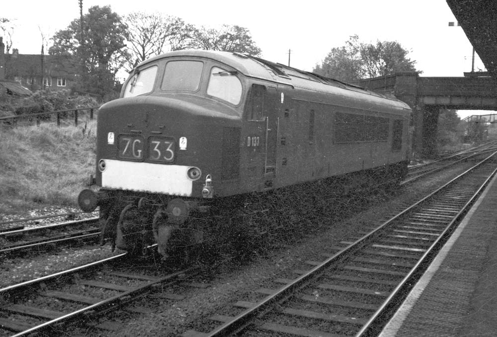British Railways 	Type 4 'Peak' D133 is seen passing light engine through the station en-route for the Kingsbury line
