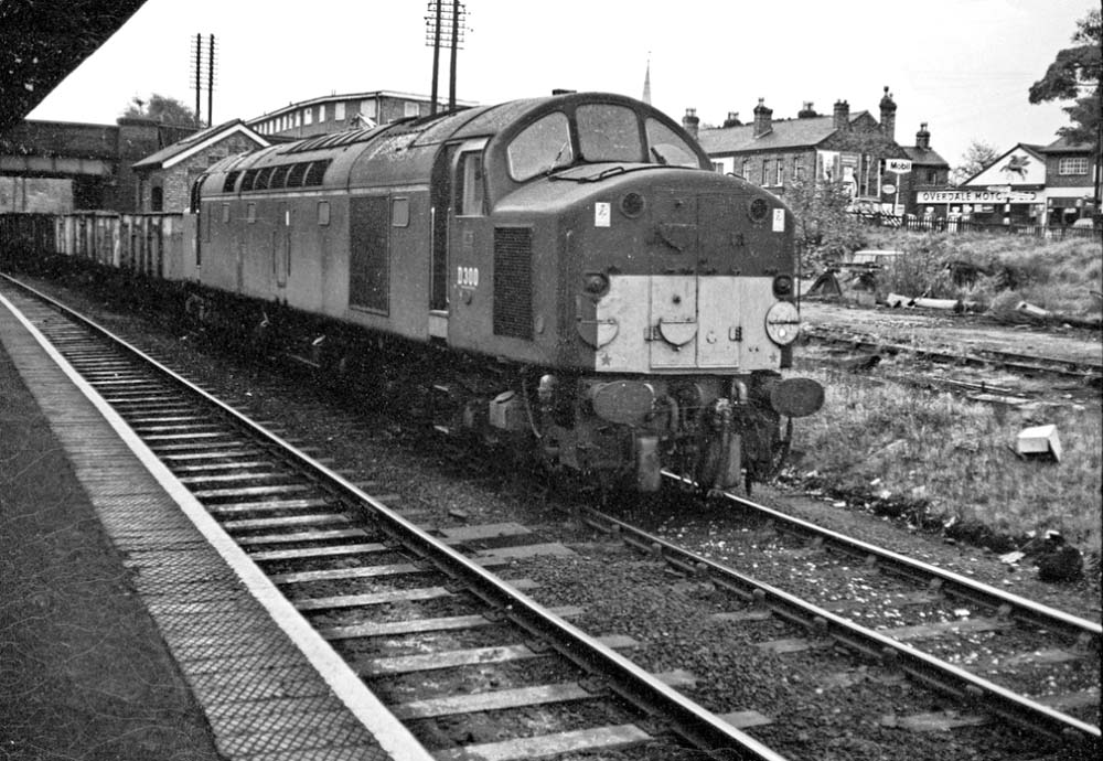 English Electric Type 4 1Co-Co1 D300 passes through the station with a train of mineral wagons in the mid 1960s
