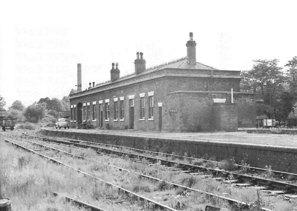 General view of the partly closed station and passenger building seen from the Leicester end of the Hampton branch platform