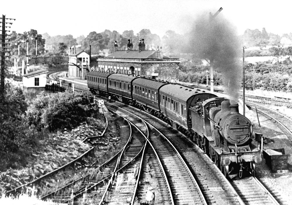 Ex-MR 2P 4-4-0 No 40452 passes through Whitacre Station with a Nuneaton to New Street service