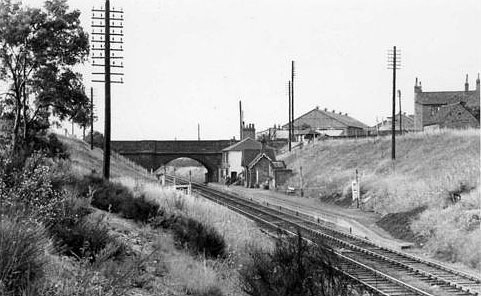 A panoramic view of Wilnecote Station seen framed by the bridge carrying Watling Street over the railway