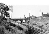 A panoramic view of Wilnecote Station seen framed by the bridge carrying Watling Street over the railway