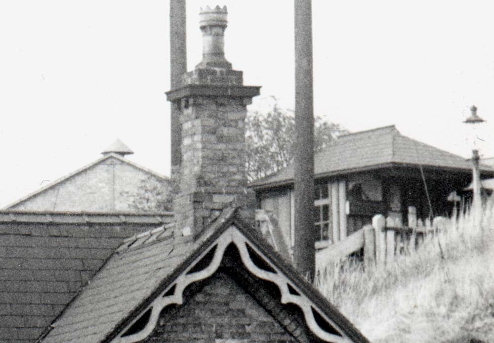 Close up showing the small timber structure with slate roof accommodating the station's booking office