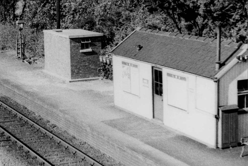 Close up showing the two basic buildings and in between them, a row of the mandatory fire buckets