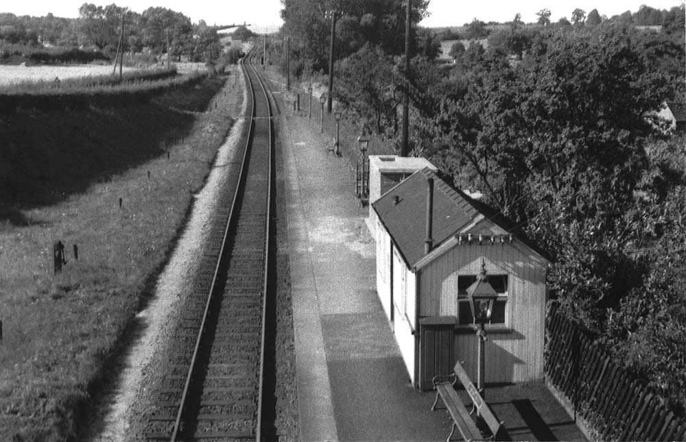View of Wixford station from the road bridge looking in the direction of Alcester showing the lane to Arrow on the left