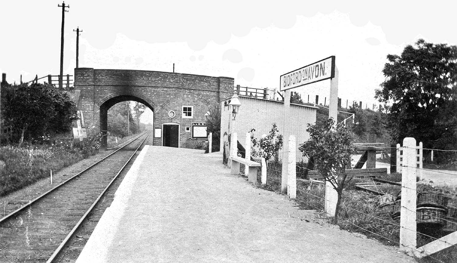 Looking along the platform towards Stratford upon Avon with the station's booking office built into the second arch of the road overbridge