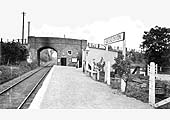 Looking along the platform towards Stratford upon Avon with the station's booking office built into the second arch of the road overbridge