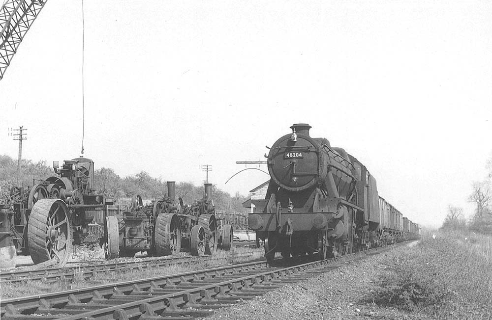Ex-LMS 8F 2-8-0 No 48204 passes by Binton station at the head of a mineral train on 25th April 1960