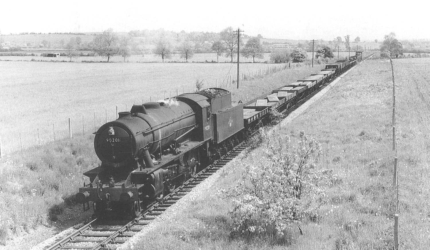 Ex-WD 2-8-0 'Austerity' No 90201 is seen on a Class H through working with a train of steel billets between Broom and Stratford