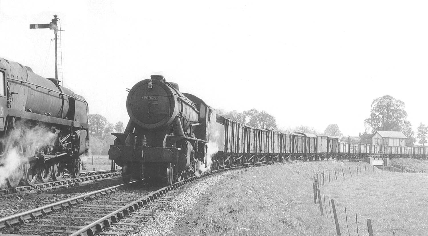 BR Standard Class 9F 2-10-0 No 92205 waits for ex-WD 2-8-0 'Austerity' No 90201 to clear the single line from Stratford upon Avon on 15th May 1960