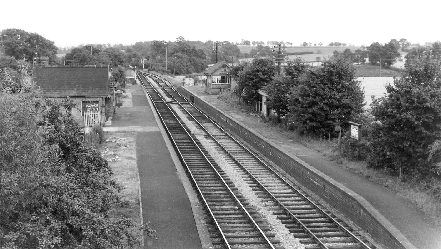 Looking towards Fenny Compton showing Ettington station's main passenger building on the up platform and signal box on the right