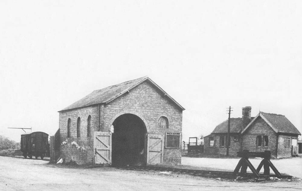 View from the station entrance of Ettington's goods shed and simple yard with the station building beyond