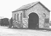 Close up showing Ettington station's brick built goods shed with its rear entrance doors open
