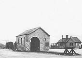 View from the station entrance of Ettington's goods shed and simple yard with the station building beyond