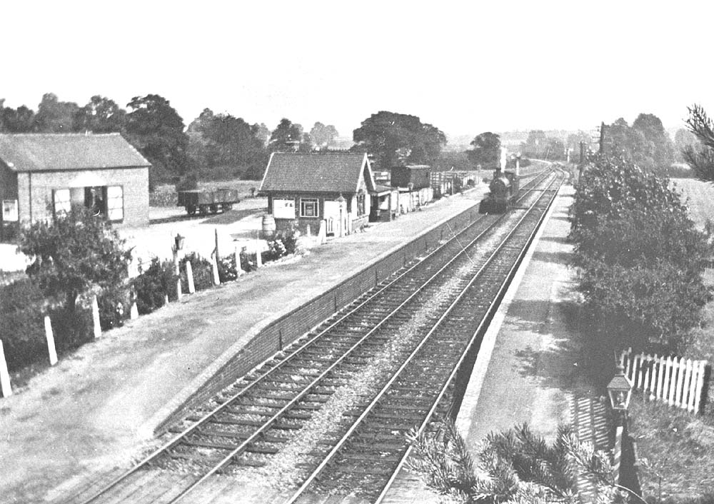 An unknown ex-LNWR 0-6-0 locomotive is seen standing light engine at the up platform opposite the signal box