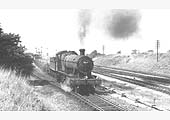 Ex-GWR 2-8-0 No 3830 is seen leaving the former Fenny Compton up platform with a goods service in 1964