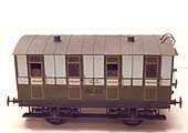 A model of a four-wheel four compartment Third Class LNWR coach dating from the 1880s