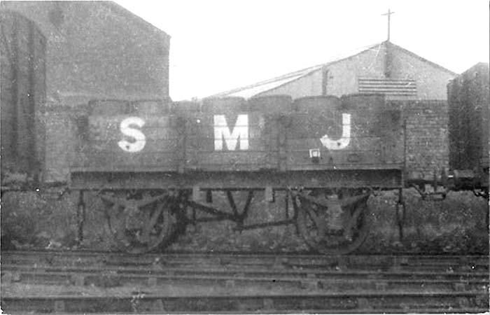 A Stratford Midland Junction 4-plank open wagon carrying goods packed in barrels