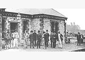An eclectic mix of people gather on the platform of Kineton station prior to the station being opened in 1871