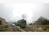 BR Standard Class 9F 2-10-0 No 92055 proceeds through the remains of Kineton station during the early 1960s