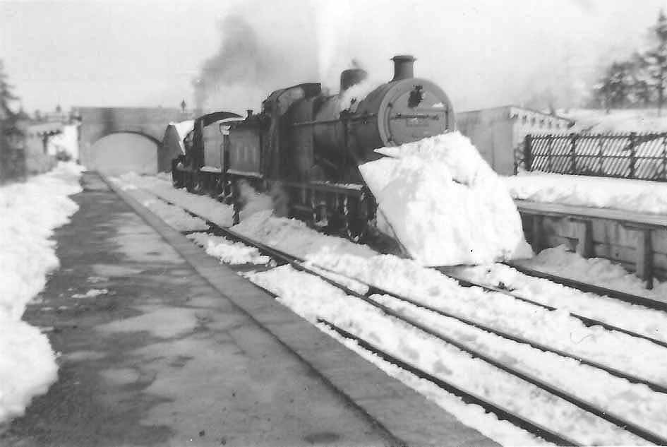 A pair of unidentified ex-LMS 4F 0-6-0 locomotives are seen clearing snow in Kineton station during the winter in early 1947