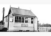 Signalman Charles Neal poses for the camera at the window of his neat and well kept signal box at Kineton station