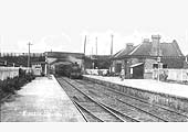 An early 1900s view of Kineton station as a train from Fenny Compton is seen passing under the road bridge
