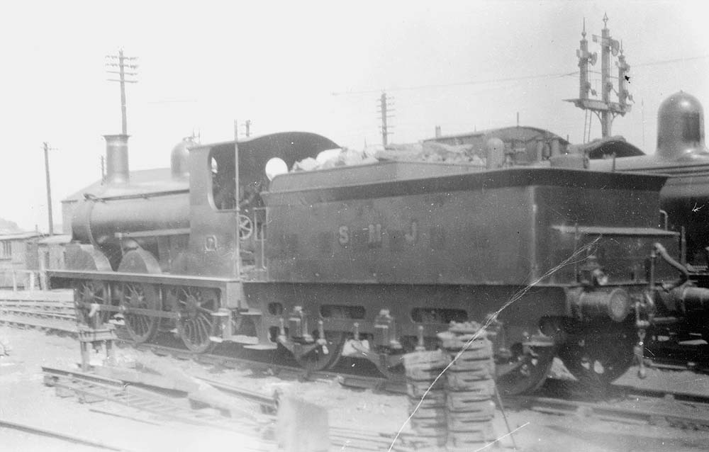 Ex-E&WJR 0-6-0 No 7, now in SMJ ownership, with Beyer Peacock tender is seen stabled fully coaled and watered outside the shed