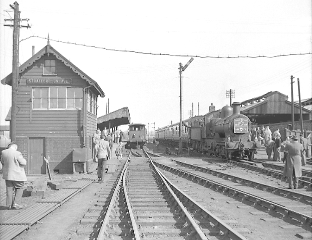 View of the LCGB's South Midlander special at the down platform with a freight service passing through the up platform
